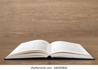 Open book on wood background - Shutterstock ID 186283826