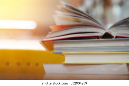 Open book on wood desk in the library room with blurred focus for education background and back to school concept - Shutterstock ID 532904239