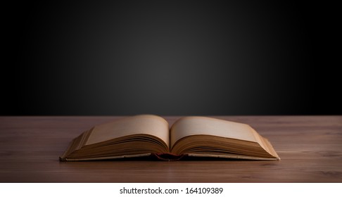 Open book on wooden deck and copy space - Shutterstock ID 164109389