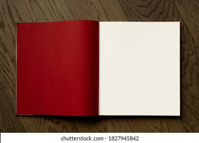 Open book on wooden table with red and white empty pages. Booklet, magazine mock up for any design or advertising  - Powered by Shutterstock