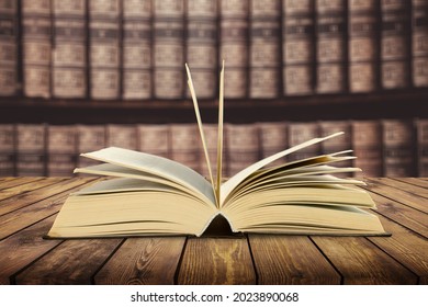 Open book on the wooden table in library - Shutterstock ID 2023890068