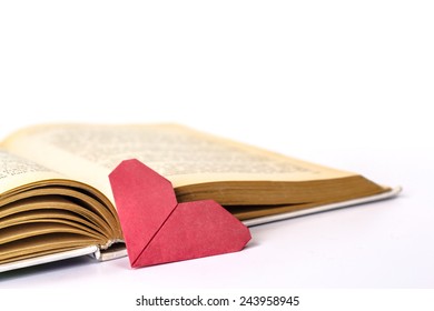 Open Book With Origami Heart Isolated On White Background