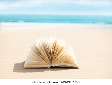 Open book in the sand on the beach - Powered by Shutterstock