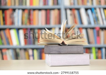 open book, stack of hardback books on wooden table. school background. copy space