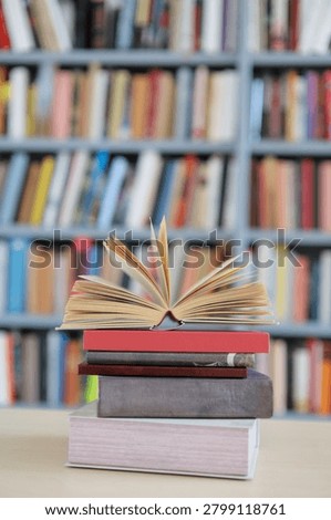 open book, stack of hardback books on wooden table. school background. copy space