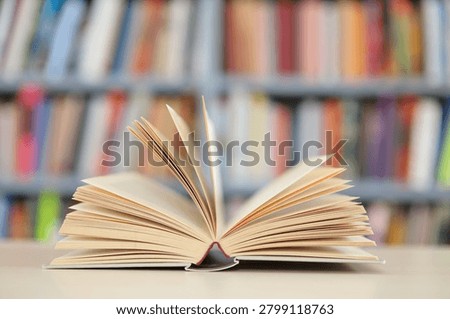 open book, stack of hardback books on wooden table. school background. copy space