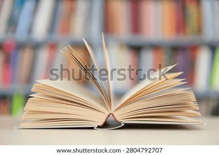 open book, stack of hardback books on wooden table. school background. copy space