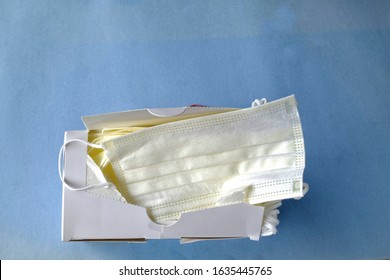 Open Box Of Medical Or Hospital Face Masks Isolated On Blue Background. No People With Copy Space