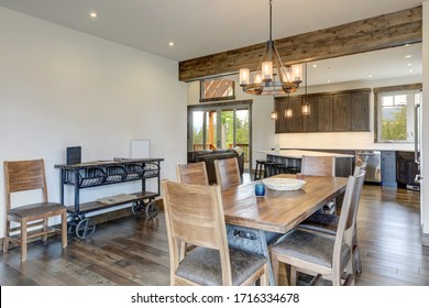 Open Bright Living Room With Long Rustic Wooden Table And Metal Modern And Cart As A Side Table.