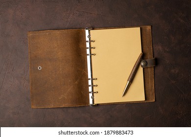 Open Brown Leather Diary On Brown Background Or Table.. Start Life From Scratch.