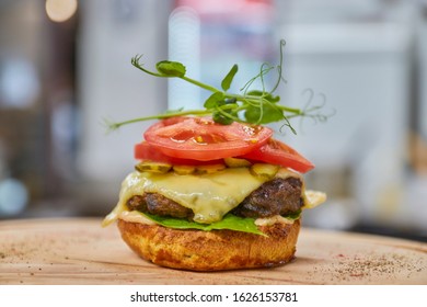 Open Burger With Beef Patty, Red Tomato And Cream Cheese Close-up