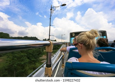 Open bus top view of tourist activity on double decker bus and motion blur