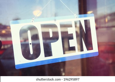 Open For Business Sign Shot Through A Dirty Diner Window