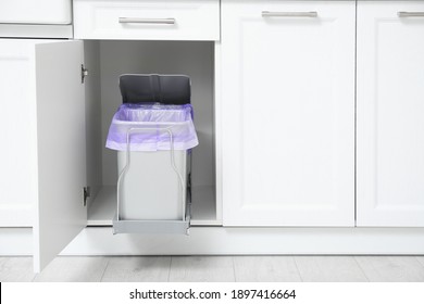 Open Cabinet With Trash Bins In Kitchen, Space For Text. Separate Waste Collection