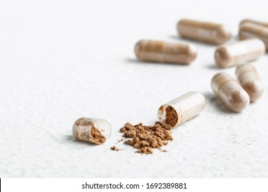 open capsule with Peruvian Maca on a white background 