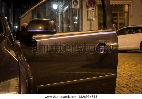 an open car\
door in artificial light at\
night