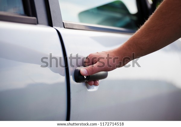 Open the car door. The man opens the car. Pull the\
door to you