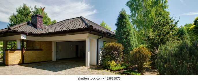 Open Car Garage In Contemoprary House With Garden