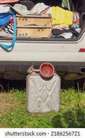 Open Car Rear Door And A Jerrycan Placed In Front Of A Vehicle, Vertical Composition