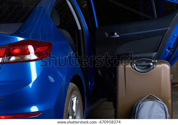 Open car rear door with luggage bags. Car\
travel background