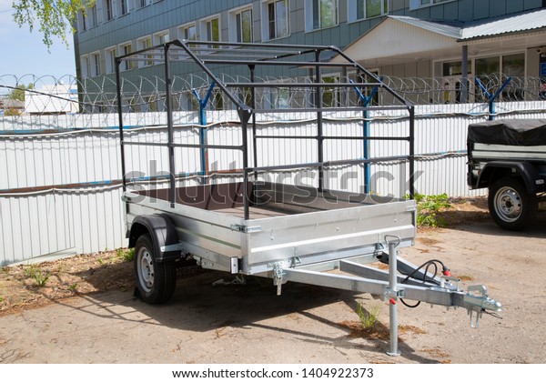 Open car trailer. Trailer store. Assembly of\
car trailers.