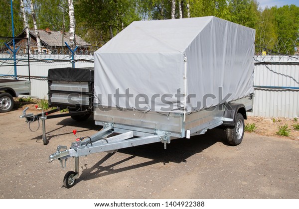 Open car trailer. Trailer store. Assembly of\
car trailers.