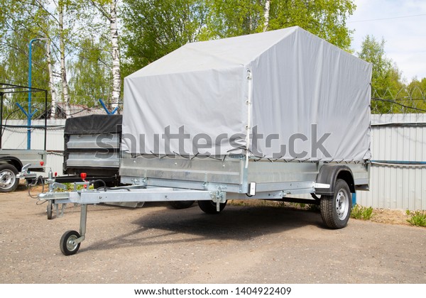 Open car trailer. Trailer store. Assembly of
car trailers.