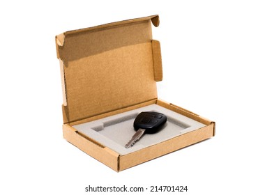 Open Cardboard Box Isolated On White With A Car Key Inside