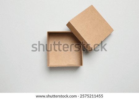 Open cardboard box on gray background