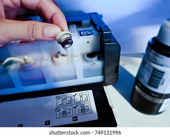 Open the cartridge. Refill ink at the printer. - Shutterstock ID 749131996