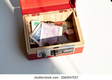 An Open Cash Box Filled With Banknotes And Coins