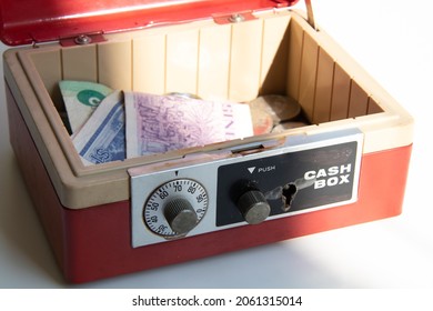 An Open Cash Box Filled With Banknotes And Coins