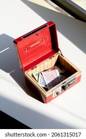 An Open Cash Box Filled With Banknotes And Coins