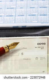 An Open Checkbook And A Ballpen, Closeup