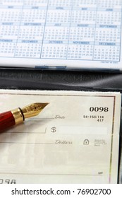 An Open Checkbook And A Ballpen, Closeup