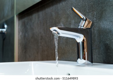 Open chrome faucet washbasin - Shutterstock ID 511649893
