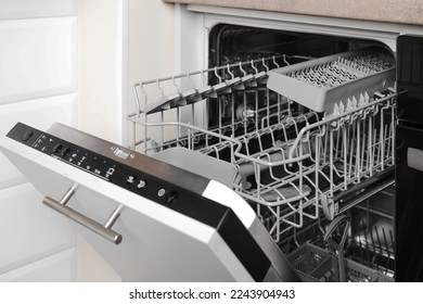 Open clean empty dishwasher in kitchen. Home appliance