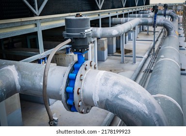 Open or close valve of cooling tower,butterfly valve beside of cooling Tower,screwing valve building cooling system,maintenance in working condition,anti-rust,rust is big problem of piping system. - Shutterstock ID 2178199923