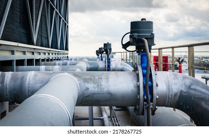 Open or close valve of cooling tower,butterfly valve beside of cooling Tower,screwing valve building cooling system,maintenance in working condition,anti-rust,rust is big problem of piping system. - Shutterstock ID 2178267725