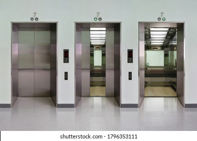 Open And Closed Chrome Metal Office Building Elevator Doors Realistic Photo. Lift Transportation Floor To Floors With Push Switch For Up And Down.