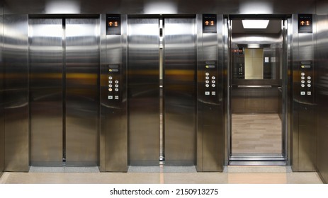 Open And Closed Chrome Metal Office Building Elevator Doors Realistic Photo. Lift Transportation Floor To Floors With Push Switch For Up And Down.