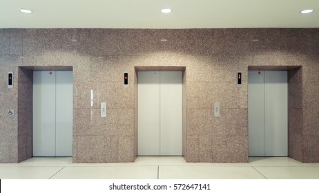 Open and closed chrome metal office building elevator doors realistic photo. Lift transportation floor to floors with push switch for up and down. Elevator disabled