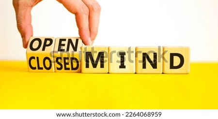 Open or closed mind symbol. Businessman turns cubes and changes concept words closrd mind to open mind. Beautiful yellow table, white background, copy space. Business open or closed mind concept.
