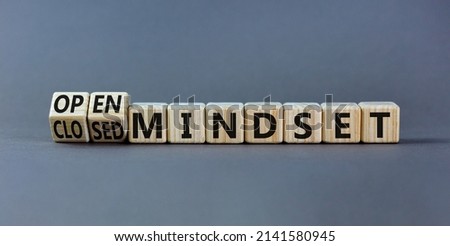 Open or closed mindset symbol. Turned wooden cubes and changed concept words closed mindset to open mindset. Beautiful grey background, copy space. Business open or closed mindset concept.