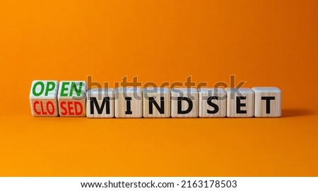 Open or closed mindset symbol. Turned wooden cubes and changed concept words closed mindset to open mindset. Beautiful orange background, copy space. Business open or closed mindset concept.
