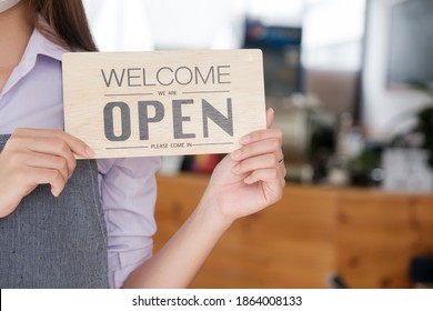 Open coffee cafe shop text on  board hanging on glass door in modern cafe coffee shop, reopening cafe restaurant, retail store, small business owner concept - Shutterstock ID 1864008133