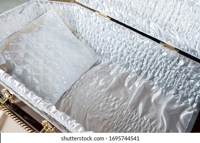 Open coffin with satin white trim and white satin pillow