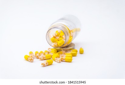 Open Container with Vitamin D3 and K2 capsules isolated on white background