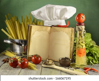 Open Cook Book With Kitchen Ware And White Toque. Vintage Kitchen Still Life.