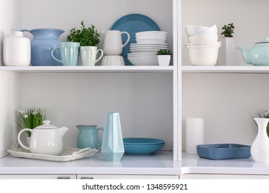 Open Cupboard With Clean Dishes In Kitchen